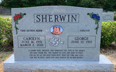granite gravestone with red and blue roses